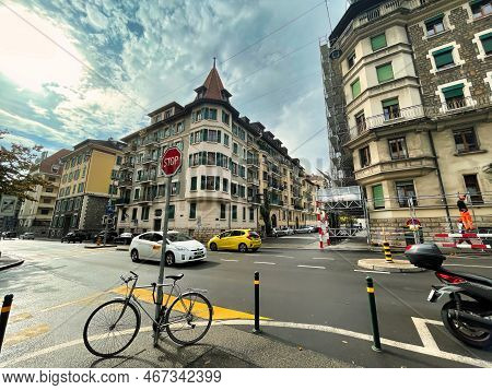 Geneva, Switzerland - September 15 2021: A Bicycle Has Been Parked Against A Pole On A Typical City 