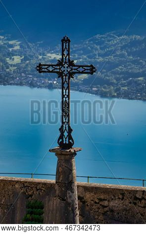 Talloires, France - September 08 2020 : An Enormous Iron Cross Of The Saint Germain Church Overlooks