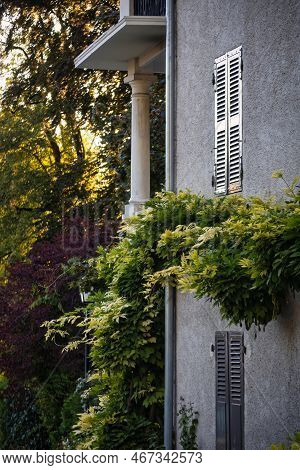 Talloires, France - September 08 2020 : An Historic Old House With Shutters, Balcony With A Column A