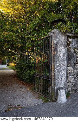 Talloires, France - September 08 2020 : An Iron Gate Fixed To Historic Stone Wall At The Entrance Dr