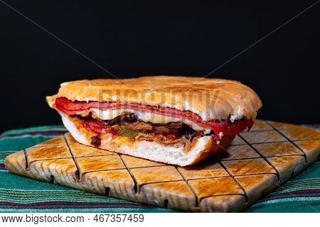 A Mexican Torta Caprichosa Grande With Milanese Pork, Leg Ham And Cheese