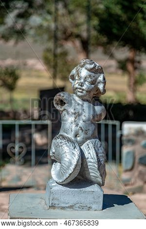 La Poma, Argentina - April 11, 2022: Damaged Statue Of A Child In The Square