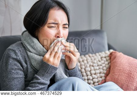 Close Up Of Young Korean Woman Staying At Home With Cold, Sneezing In Napking, Has Runny Nose, Conce