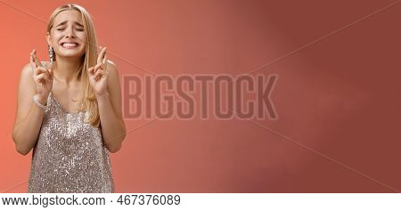 Nervous Hopeful Blond Young Woman In Silver Trendy Dress Close Eyes Grimacing Eager Wish Come True C