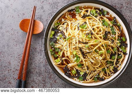 Korean Cold Noodle Soup Memil Guksu With Green Onions, Sesame And Seaweed Closeup In The Bowl On The