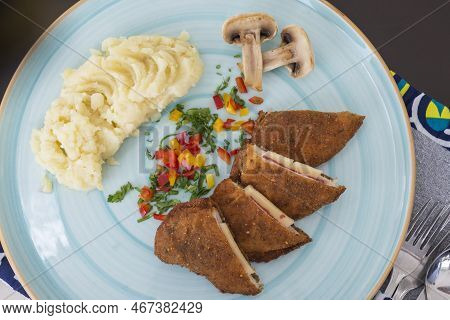 Stuffed Chicken Panne A La Carte Meal With Mushrooms And Mashed Potato At Restaurant Table Setting
