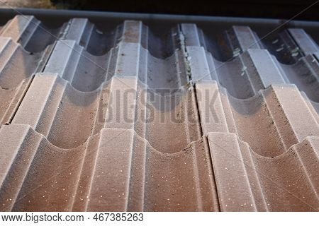 Thin Ice On A Brown Roof In Winter