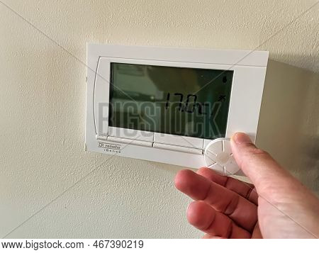 Den Haag, Netherlands - November 04 2021 : The Hand Of A Person Is Visible Loweing The Temperature O