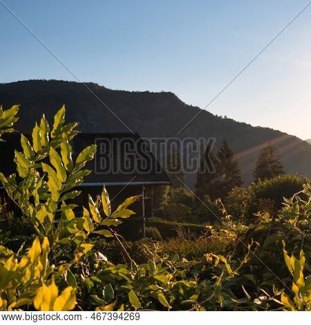 Talloires, France - September 08 2020 : Sun Beams Shining On A Small House Or Lodge In The Mountains