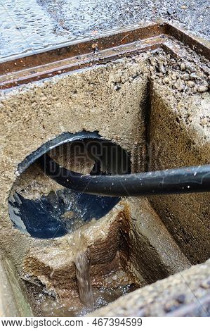 With Hose Under High Pressure Cleaning A Sewer Tube
