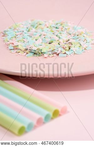 Drinking Straws And Plate Full Of Microplastics On A Pink Background. Impact Of Micro Plastic On The