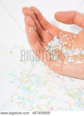 Shot Of Microplastics Lay On Human Hand. Concept Of Water Pollution And Global Warming. The Idea Of