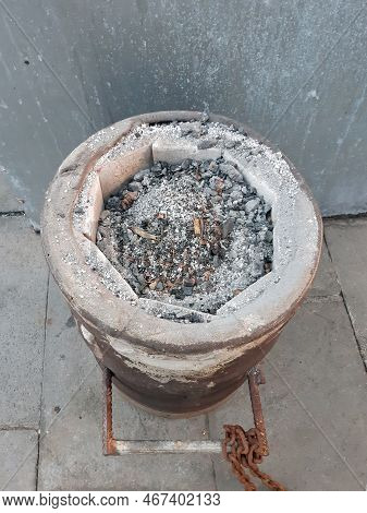 Aerial View Of Brazier For Roasting With Ashes And Remains Of Cigarette Butts. Old And Rusty Stove. 
