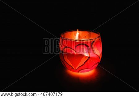 Glass Candlestick. Burning Candle On A Black Background. Romantic Atmosphere For Valentines Day. Dec