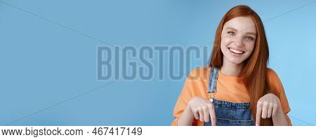 Friendly Happy Redhead Girl Smiling Lively Pretty Grin Pointing Down Index Fingers Offering Good Off