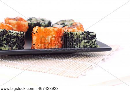 Different Types Of Maki Sushi On A Black Plate