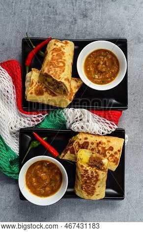 Mexican Burritos With Chorizo, Potato, Cheese And Beef Served With Sauce Barracha