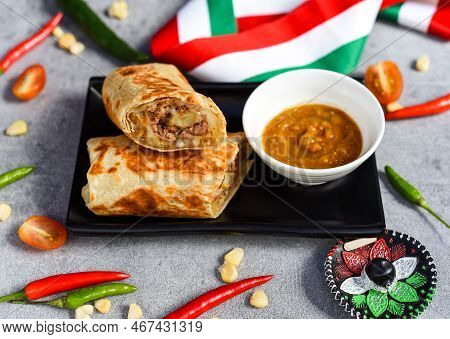 Mexican Burrito With Beef, French Fries And Cheese Served With Sauce Borracha