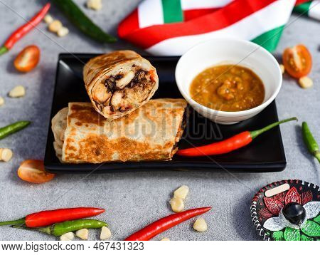 Mexican Burrito With Chicken, Rice,beans And Cheese Served With Sauce Barracha