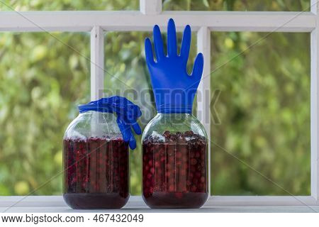 Homemade Tincture Of Red Cherry In A Jar With A Glove Shaped Shutter. Berry Alcoholic Drinks Concept