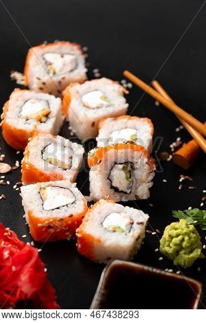 The Range Of Different Types Of Japanese Sushi And Rolls. On Dark Rustic Background. Rolls On A Dark