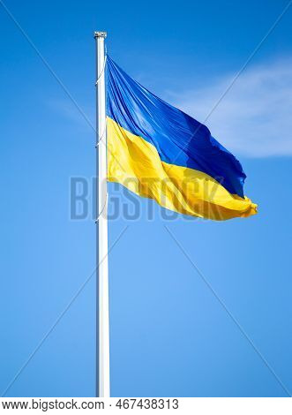 Flag Of Ukraine Against The Blue Sky Close-up. National Pride And Symbol Of The Country Ukraine. War