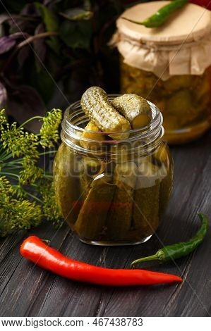 Pickled Cucumbers In A Jars On A Dark Wooden Background. Homemade Marinated Cucumbers. Pickled Cucum