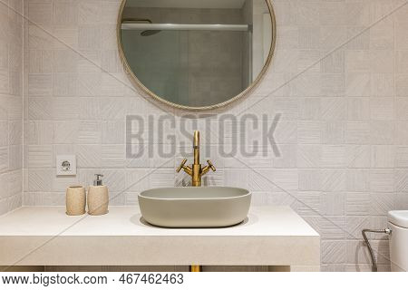 Oval Stylish Sink On White Smooth Marble Countertop In Modern Bathroom. Copper-colored Two-valve Fau