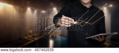 Businessman Working On Virtual Computer Screen With Financial Market Graph.