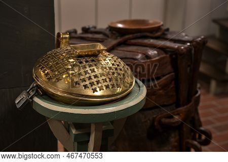 Offertory Box Made Of Brass With An Iron Lock In A Christian Church, Used To Collect Money For Chari