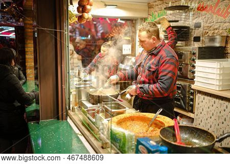 Dusselldorf, Germany - December 13, 2022: Women Preparing Langosh, A Traditional Hungarian Rich Flat