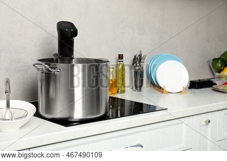 Pot With Sous Vide Cooker In Kitchen. Thermal Immersion Circulator