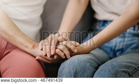 Hands Of The Old Woman And A Wman Hand In Home