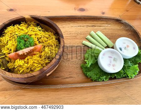 Rice Lamb Biryani Pilaf With Lamb Or Mutton Meat And Vegetables Cucumber Along With Yoghurt In A Ver