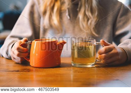 Portrait Of A Joyful Teengirl Enjoying A Cup Of Tea At Cafe. Smiling Beautiful Girl Drinks Hot Tea I