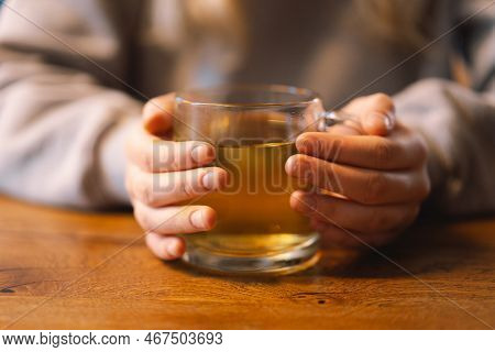 Portrait Of A Joyful Teengirl Enjoying A Cup Of Tea At Cafe. Smiling Beautiful Girl Drinks Hot Tea I