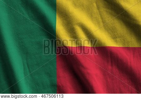 Benin Flag With Big Folds Waving Close Up Under The Studio Light Indoors. The Official Symbols And C
