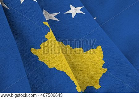 Kosovo Flag With Big Folds Waving Close Up Under The Studio Light Indoors. The Official Symbols And 