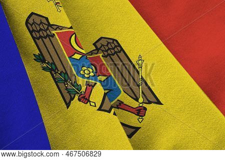Moldova Flag With Big Folds Waving Close Up Under The Studio Light Indoors. The Official Symbols And