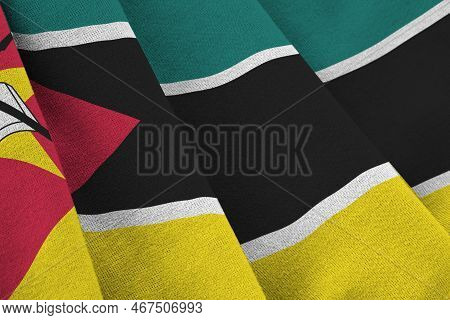 Mozambique Flag With Big Folds Waving Close Up Under The Studio Light Indoors. The Official Symbols 
