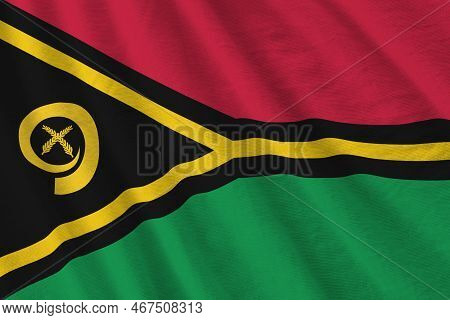 Vanuatu Flag With Big Folds Waving Close Up Under The Studio Light Indoors. The Official Symbols And