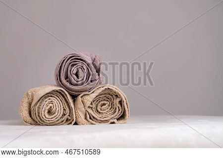Close-up Of A Composition With Three Twisted Towels On A Massage Table In A Spa, Copy Space