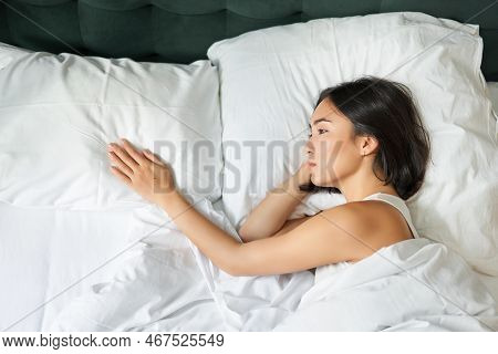 Portrait Of Romantic Asian Woman Lying Alone In Her Bed, Touching Empty Pillow And Thinking About He