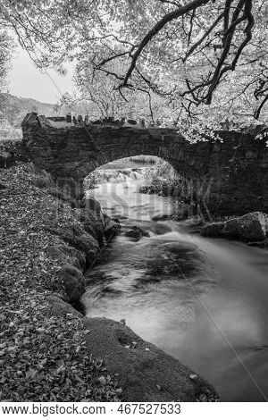 The Weir Water River Flowing Under Robbers Bridge In Exmoor National Park
