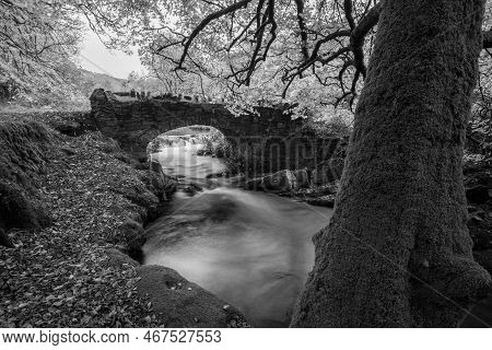 The Weir Water River Flowing Under Robbers Bridge In Exmoor National Park