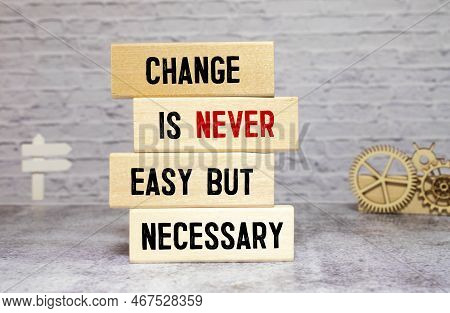 Wooden Blocks With Words 'change Is Never Easy But Necessary'.