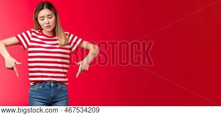 Disappointed Gloomy Blond Asian Girl Sighing Upset Looking Pointing Fingers Down, Express Regret Sor