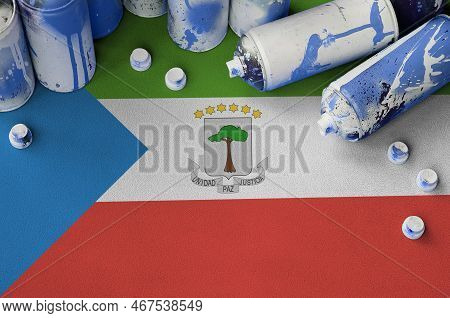 Equatorial Guinea Flag And Few Used Aerosol Spray Cans For Graffiti Painting. Street Art Culture Con