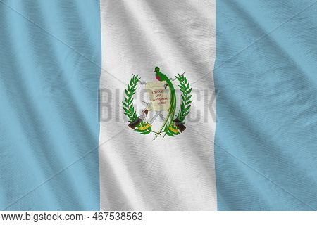 Guatemala Flag With Big Folds Waving Close Up Under The Studio Light Indoors. The Official Symbols A