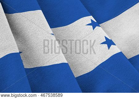 Honduras Flag With Big Folds Waving Close Up Under The Studio Light Indoors. The Official Symbols An